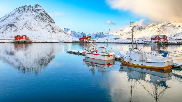 Bateaux de pêche dans les îles Lofoten avec un paysage hivernal.