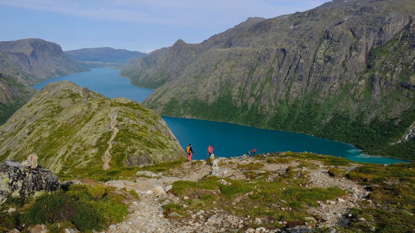 Hikers at Lake Gjende in Norway.